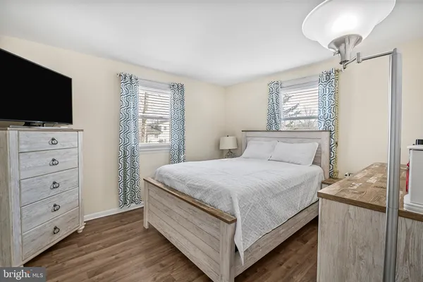 a bedroom with a bed and flat screen tv