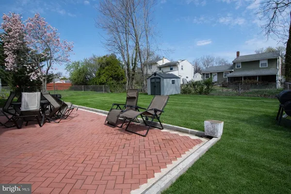 a view of a patio with a table chairs and a yard