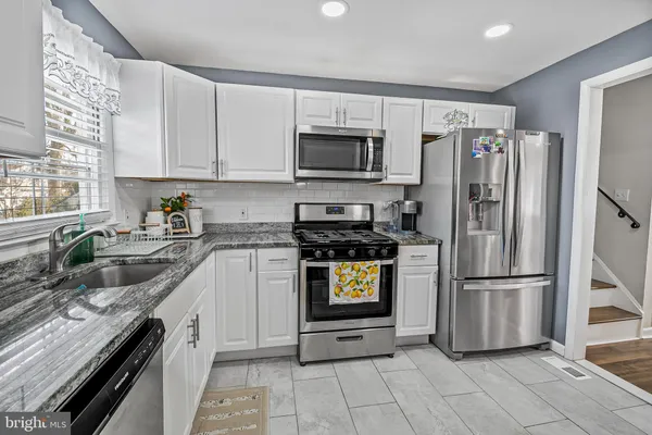 a kitchen with a refrigerator stove and microwave