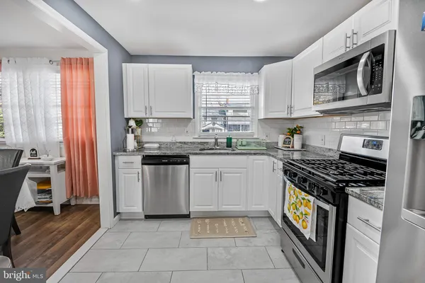a kitchen with a stove a sink and a microwave