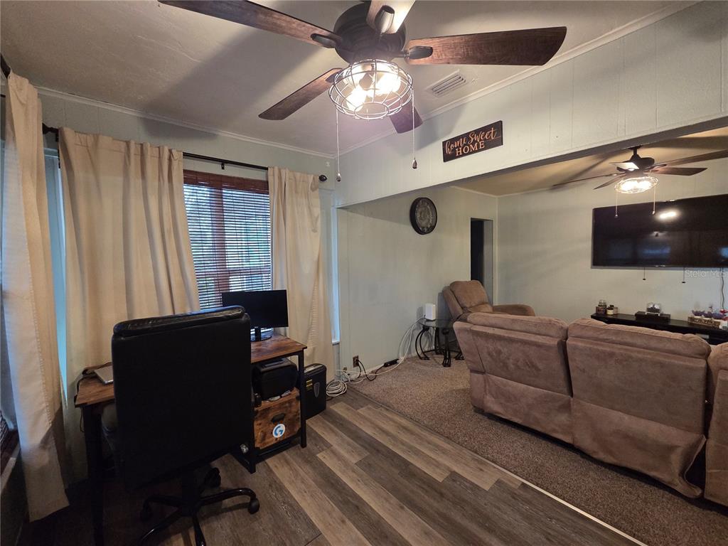 124 East F Street Frostproof, FL 33843 - Photo 8 of 37 a living room with furniture and a flat screen tv