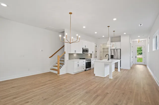 an empty room with windows and ceiling fan