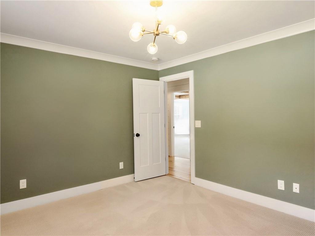 4925 Cook Road Southwest Stockbridge, GA 30281 - Photo 18 of 32 a view of a room with a chandelier fan and a window