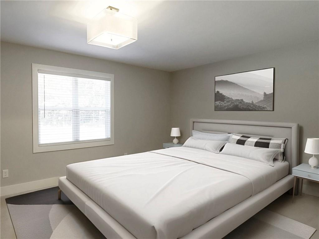 4925 Cook Road Southwest Stockbridge, GA 30281 - Photo 20 of 32 a bedroom with a large bed and a window