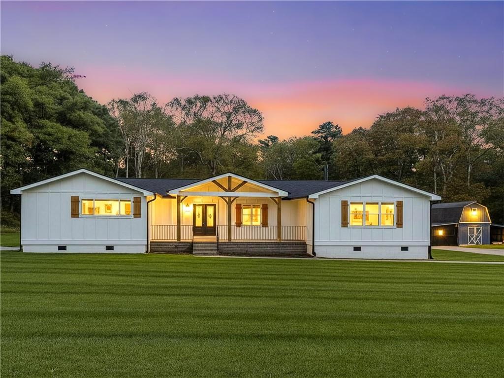4925 Cook Road Southwest Stockbridge, GA 30281 - Photo 2 of 32 a front view of a house with a big yard and a garden
