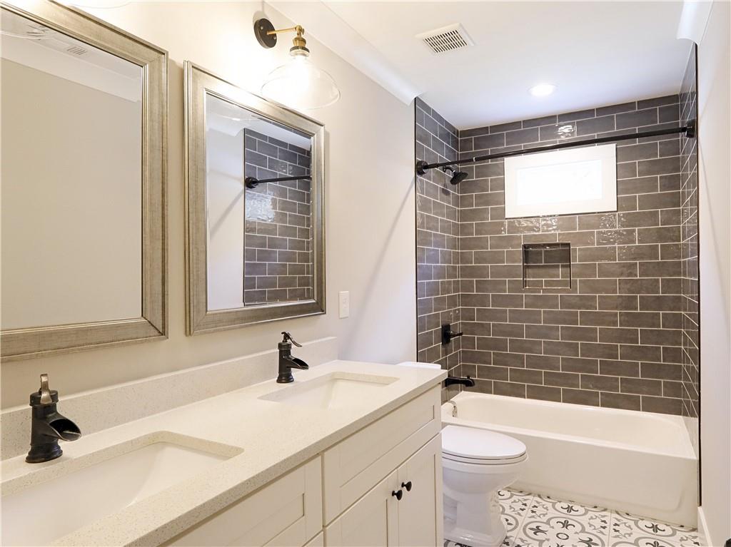 4925 Cook Road Southwest Stockbridge, GA 30281 - Photo 22 of 32 a bathroom with a sink a toilet and shower