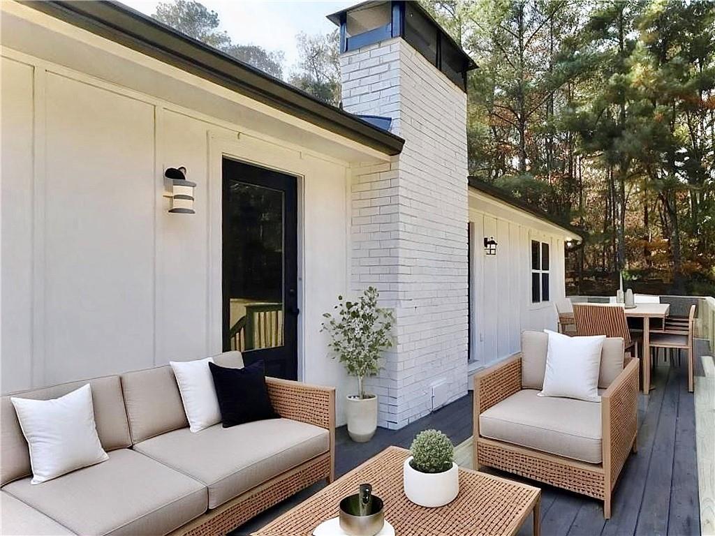 4925 Cook Road Southwest Stockbridge, GA 30281 - Photo 27 of 32 a view of a patio with couches and a potted plant on a table