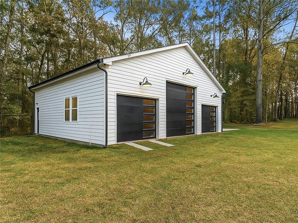 4925 Cook Road Southwest Stockbridge, GA 30281 - Photo 30 of 32 a view of a house with a yard and garage