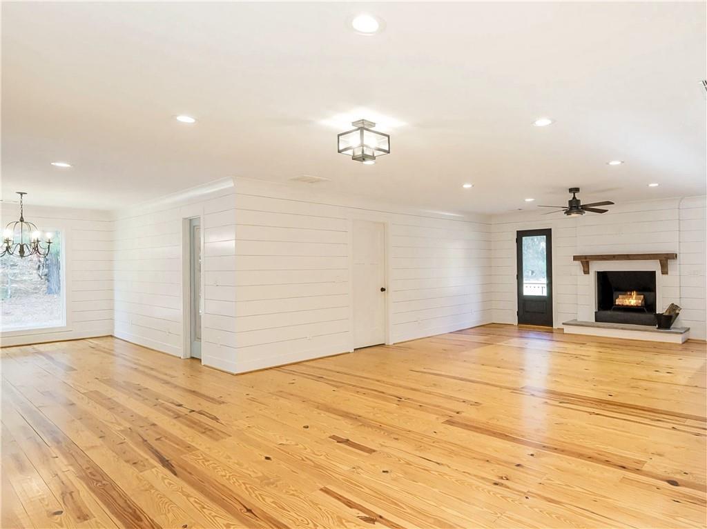 4925 Cook Road Southwest Stockbridge, GA 30281 - Photo 4 of 32 a view of empty room with wooden floor and fireplace