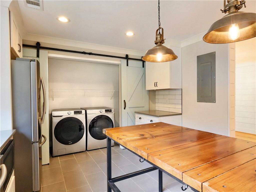 4925 Cook Road Southwest Stockbridge, GA 30281 - Photo 10 of 32 a room with a chandelier and fireplace