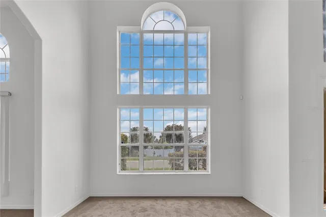 a view of a livingroom with wooden floor and a window