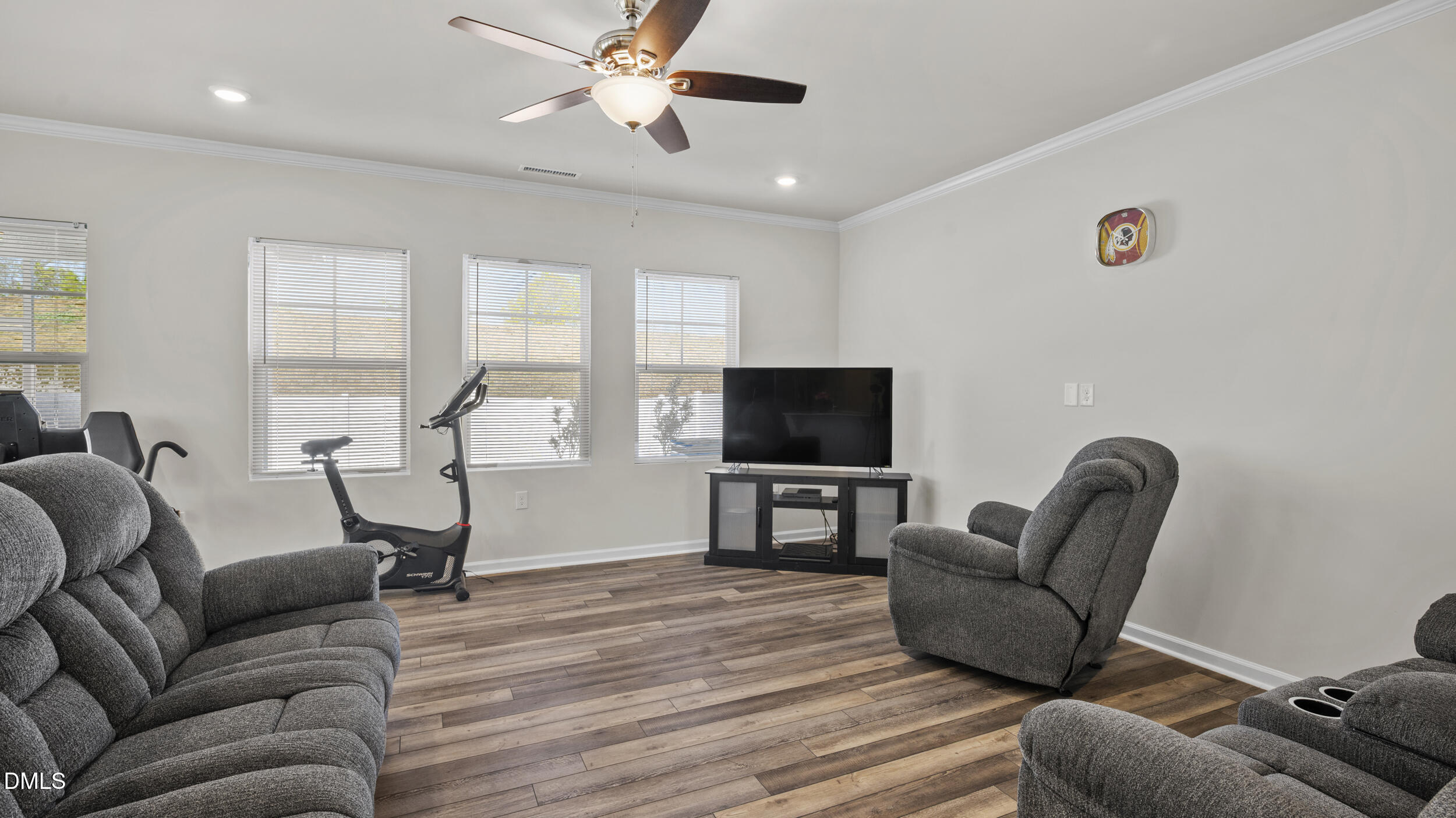 333 Glacier Lk Drive Raleigh, NC 27610 - Photo 12 of 32 a living room with furniture a ceiling fan and a flat screen tv