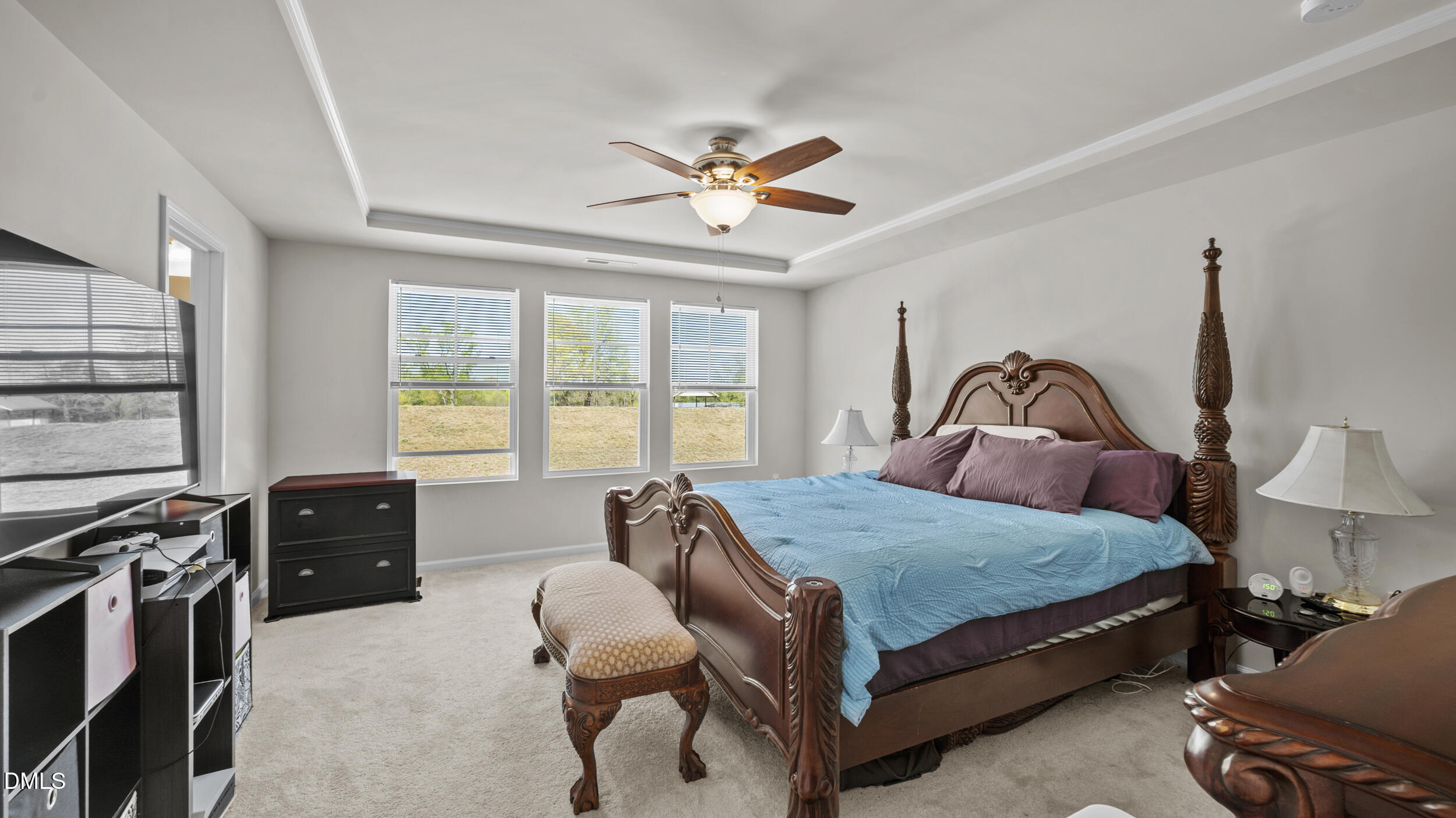 333 Glacier Lk Drive Raleigh, NC 27610 - Photo 17 of 32 a bedroom with a bed and a chandelier