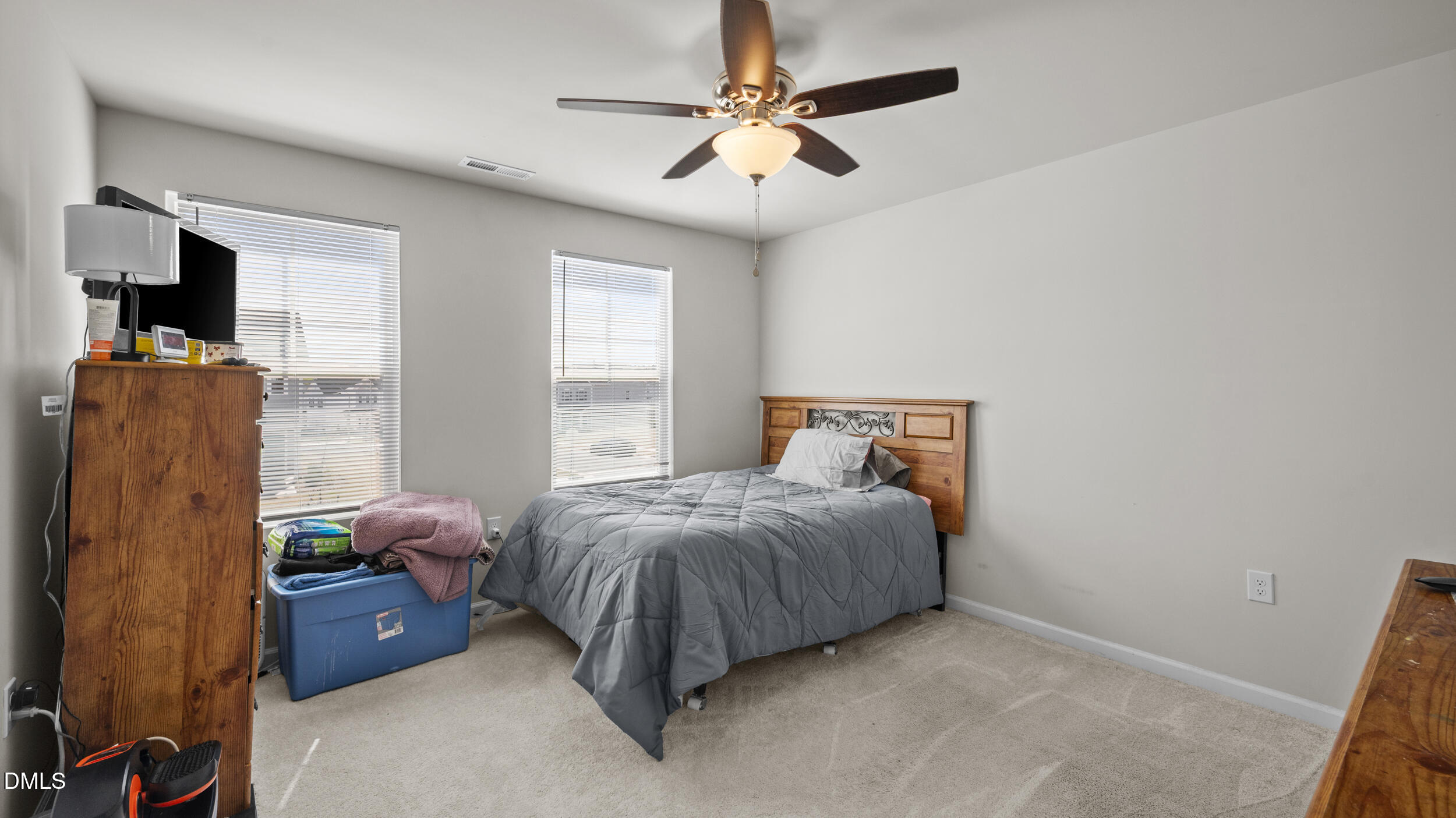 333 Glacier Lk Drive Raleigh, NC 27610 - Photo 23 of 32 a bedroom with a bed and a chandelier