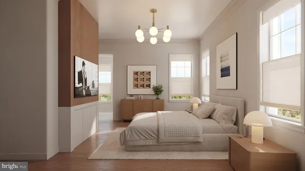 a bedroom with a large bed and a chandelier