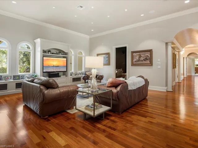 a bedroom with two beds and a flat screen tv