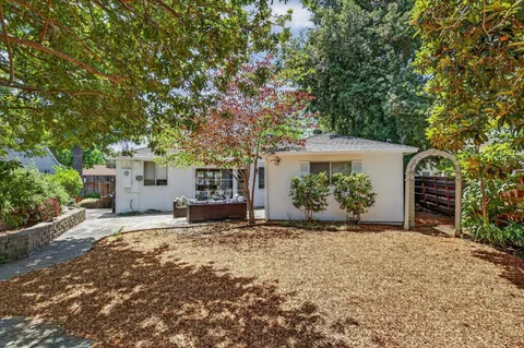 a view of a house with a tree in front