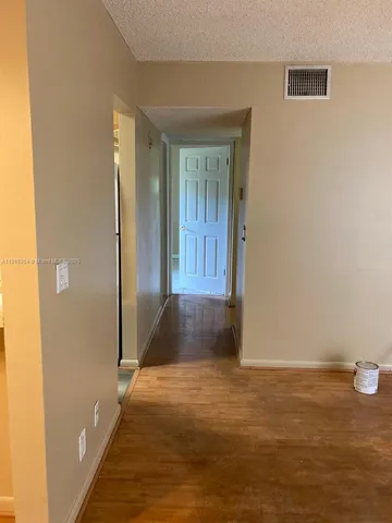 a bathroom with a shower curtain and a toilet