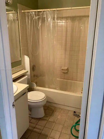 a white toilet sitting next to a bathroom sink