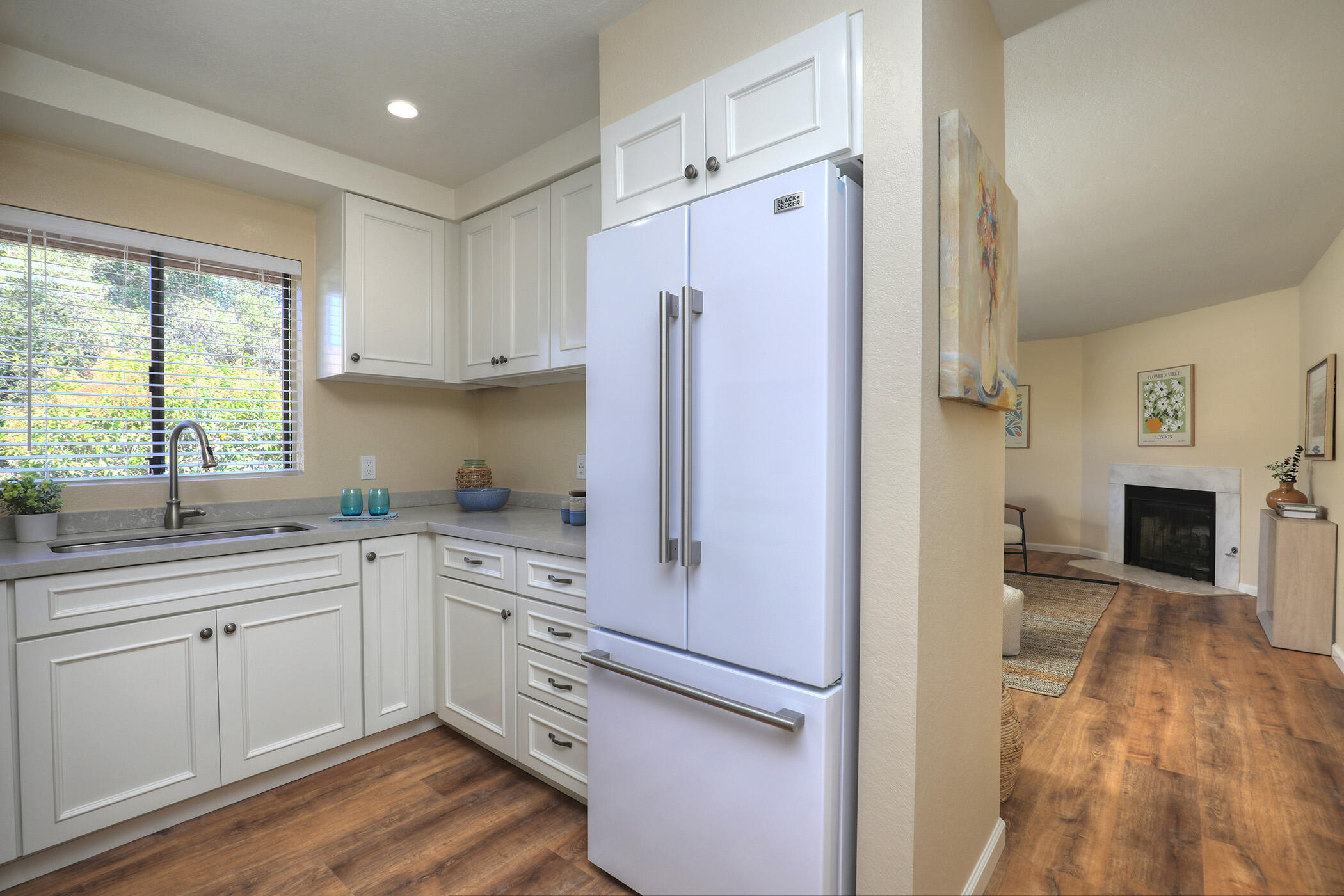 1815 Bath Street, Unit 4 Santa Barbara, CA 93101 - Photo 5 of 19 a kitchen with white cabinets and white appliances