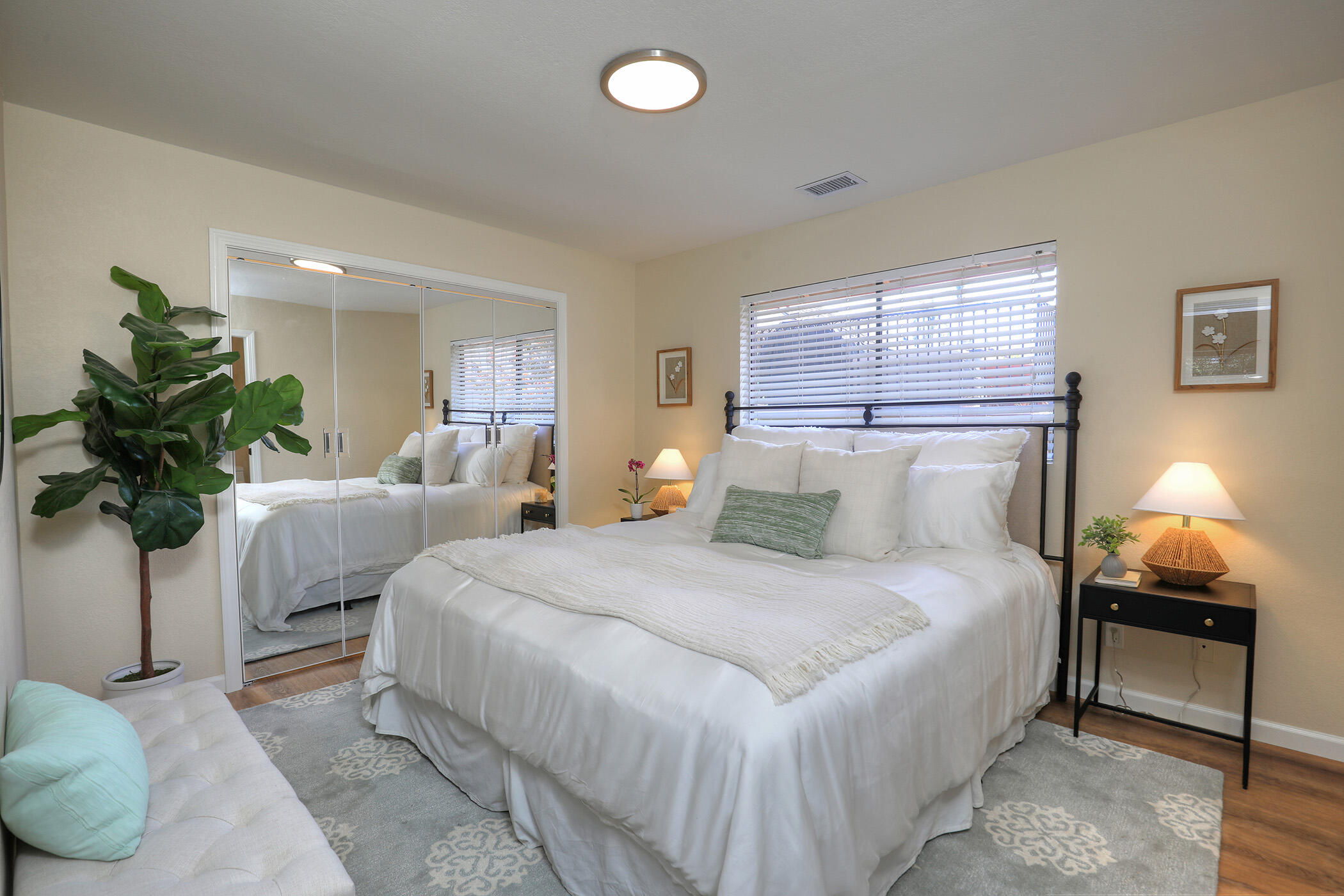 1815 Bath Street, Unit 4 Santa Barbara, CA 93101 - Photo 8 of 19 a bedroom with a bed and a lamp
