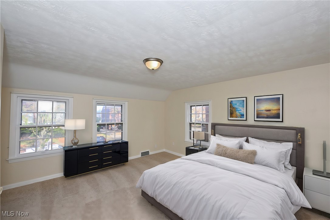 3938 Lansdale Road Cleveland, OH 44118 - Photo 20 of 34 Bedroom with multiple windows, light carpet, and a textured ceiling