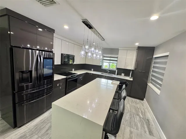 a kitchen with a refrigerator a sink and cabinets