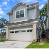 a front view of house with a garden