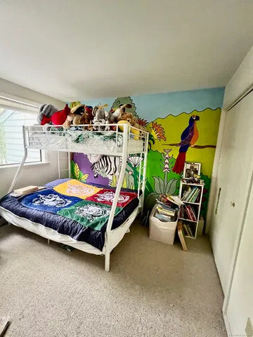 a bed sitting in a bedroom next to a window