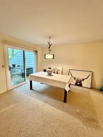 a living room with furniture and a floor to ceiling window