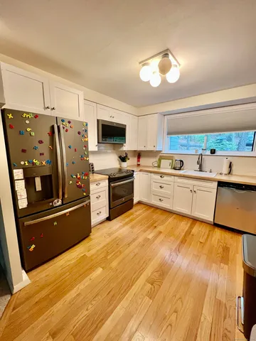 a large kitchen with cabinets and stainless steel appliances