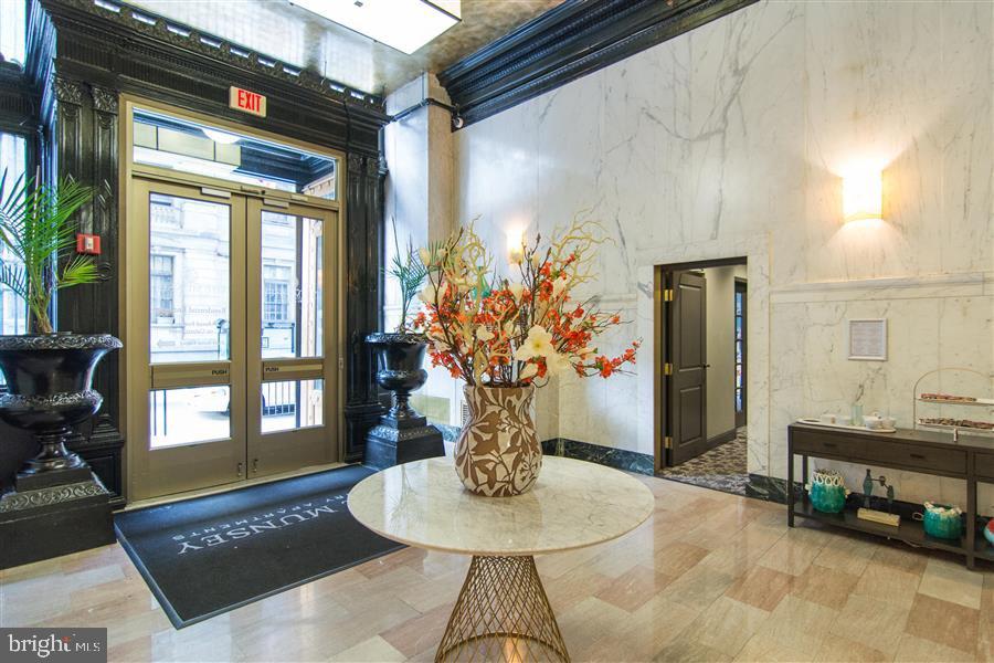 7 North Calvert Street, Unit 1BR Baltimore, MD 21202 - Photo 11 of 32 a vase of flowers sitting on a table in front of a window