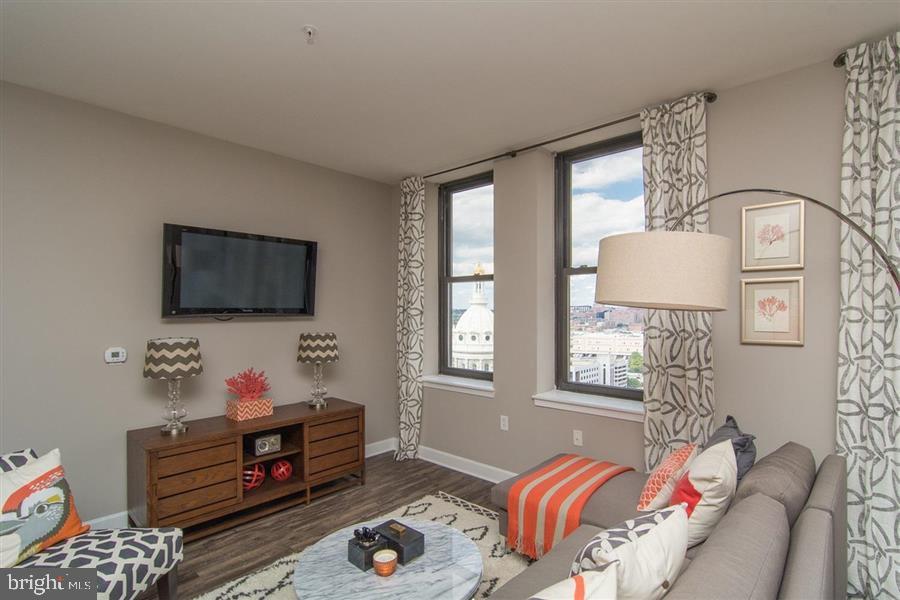 7 North Calvert Street, Unit 1BR Baltimore, MD 21202 - Photo 27 of 32 a living room with furniture and a flat screen tv