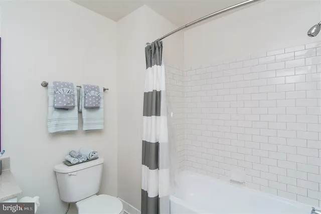 a bedroom with a bed and a television