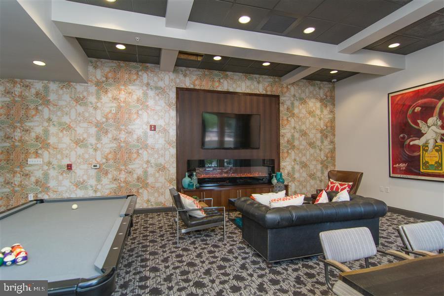 7 North Calvert Street, Unit 1BR Baltimore, MD 21202 - Photo 8 of 32 a living room with furniture and a flat screen tv