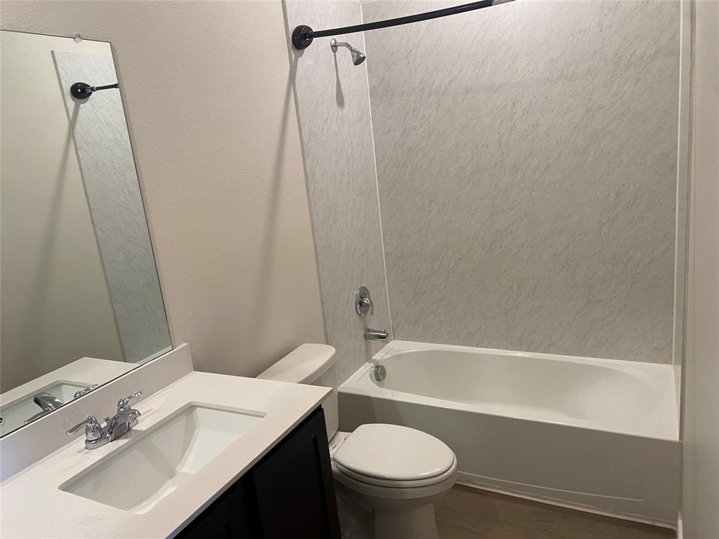 2157 Crooked Bow Drive, Unit 2157 Mesquite, TX 75149 - Photo 3 of 8 a bathroom with a sink a toilet and shower