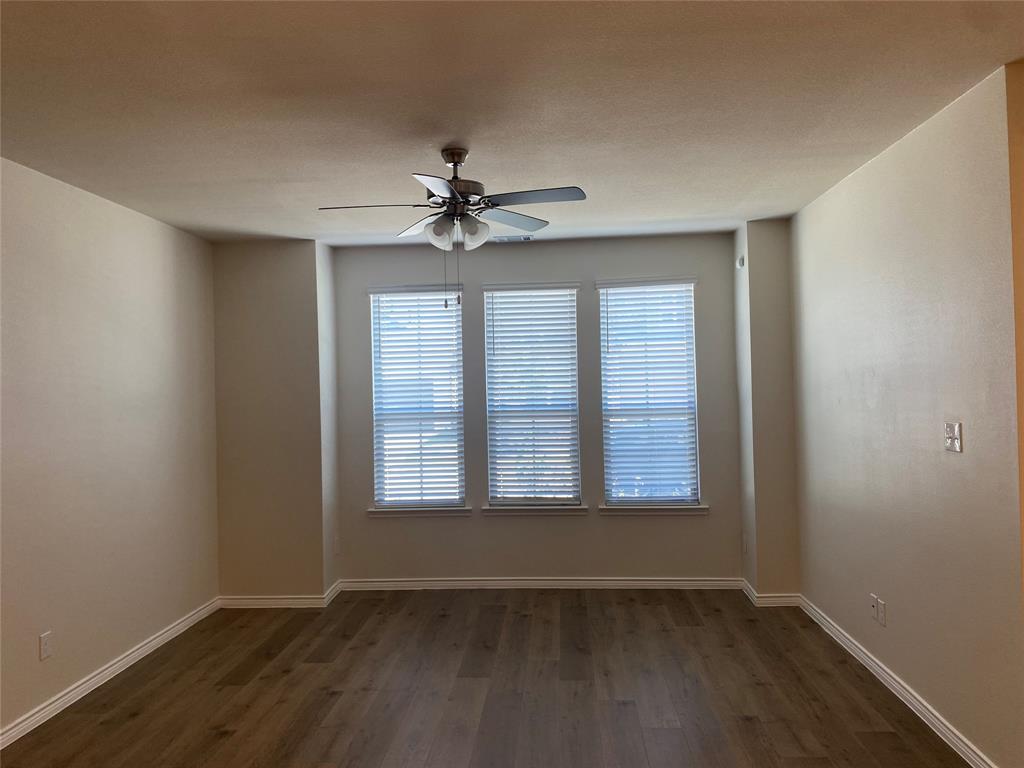 2157 Crooked Bow Drive, Unit 2157 Mesquite, TX 75149 - Photo 4 of 8 a view of an empty room with a window and wooden floor