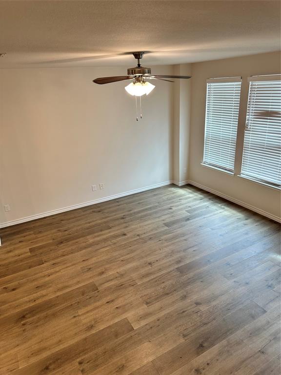 2157 Crooked Bow Drive, Unit 2157 Mesquite, TX 75149 - Photo 7 of 8 wooden floor in an empty room with a window