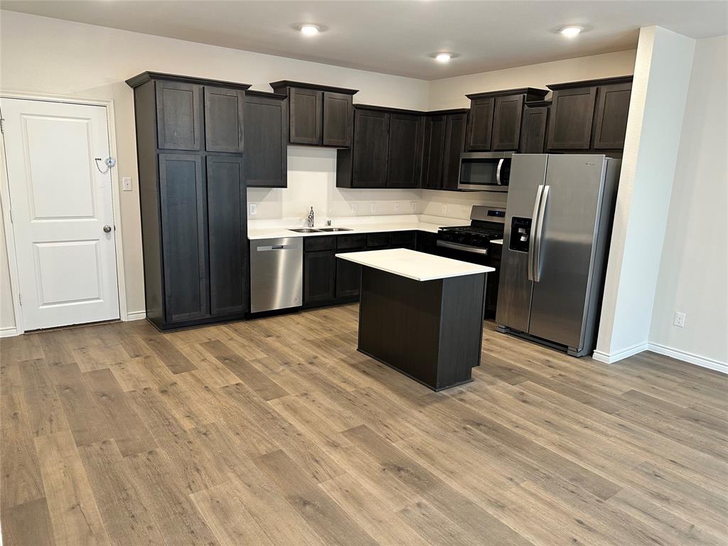 2157 Crooked Bow Drive, Unit 2157 Mesquite, TX 75149 - Photo 8 of 8 a kitchen with stainless steel appliances a refrigerator and a stove top oven
