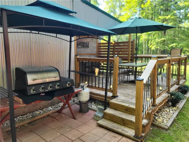 a roof deck with table and chairs