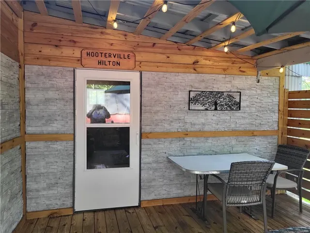 a view of a door with a chair and table