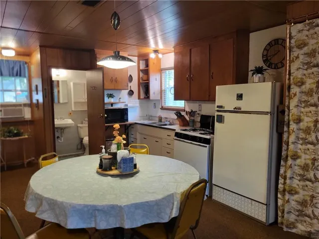 a kitchen with a refrigerator and a table