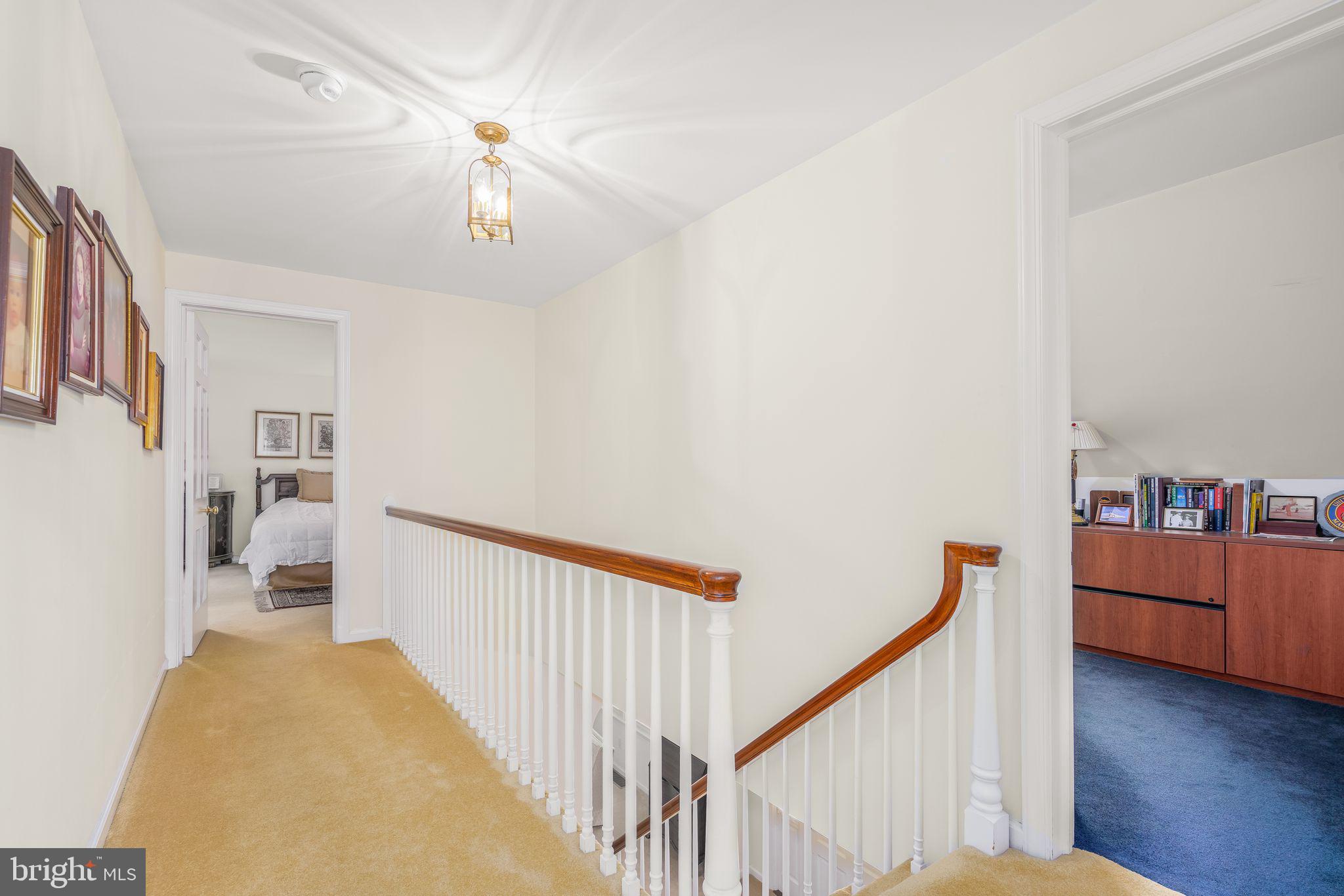 624 Warwick Road Haddonfield, NJ 08033 - Photo 27 of 43 a view of a hallway with workspace and wooden floor