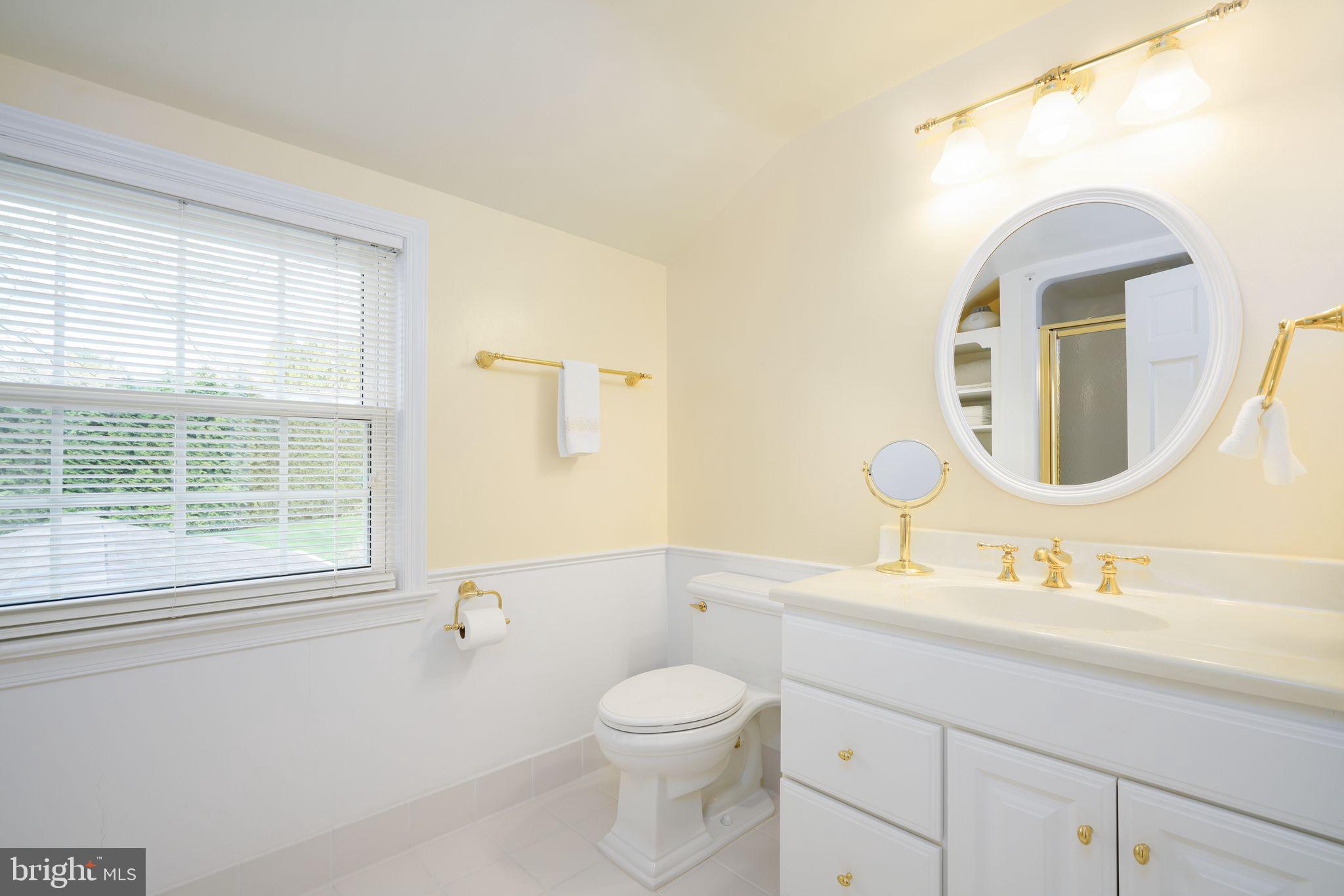 624 Warwick Road Haddonfield, NJ 08033 - Photo 34 of 43 a bathroom with a toilet a sink a mirror and a window
