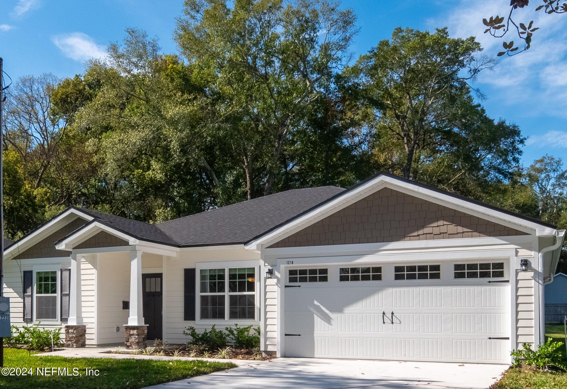 4011 Spring Glen Road Jacksonville, FL 32207 - Photo 1 of 38 a front view of a house with a yard