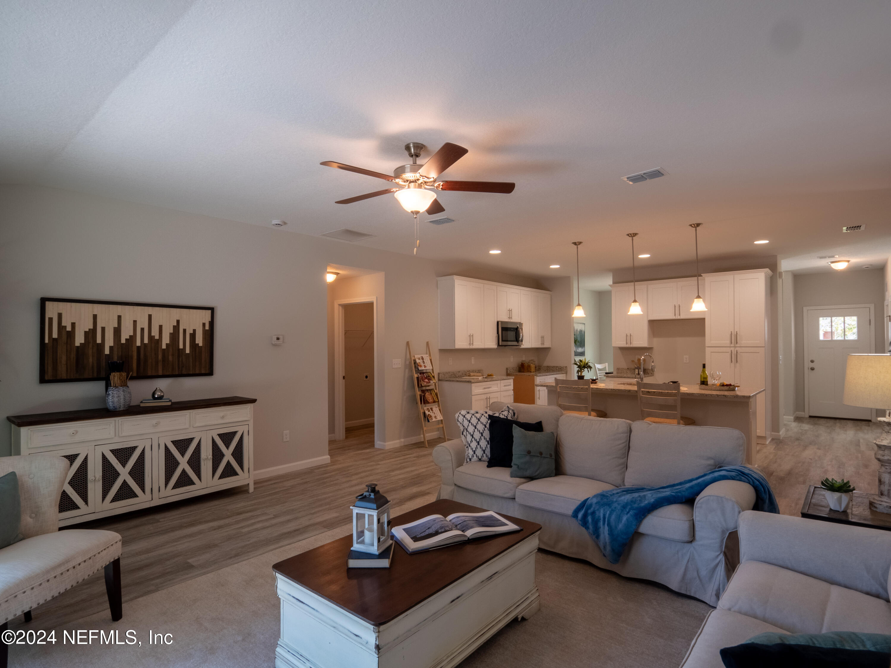 4011 Spring Glen Road Jacksonville, FL 32207 - Photo 21 of 38 a living room with furniture kitchen view and a chandelier
