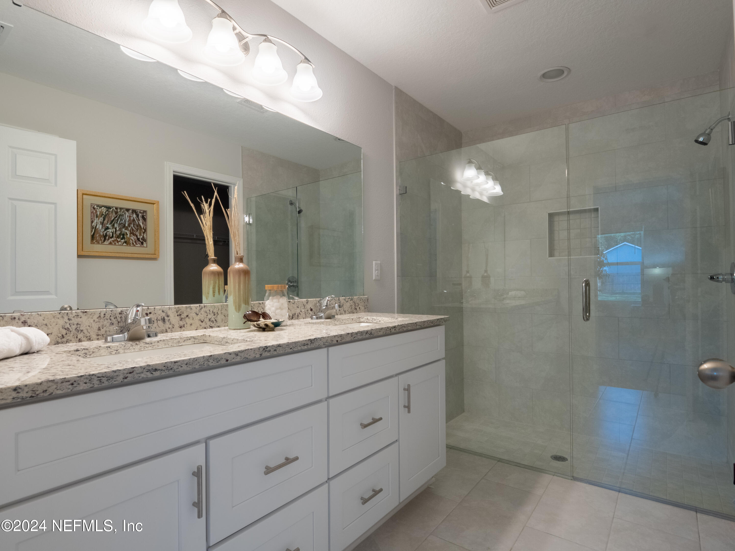4011 Spring Glen Road Jacksonville, FL 32207 - Photo 28 of 38 a bathroom with a granite countertop sink mirror and double