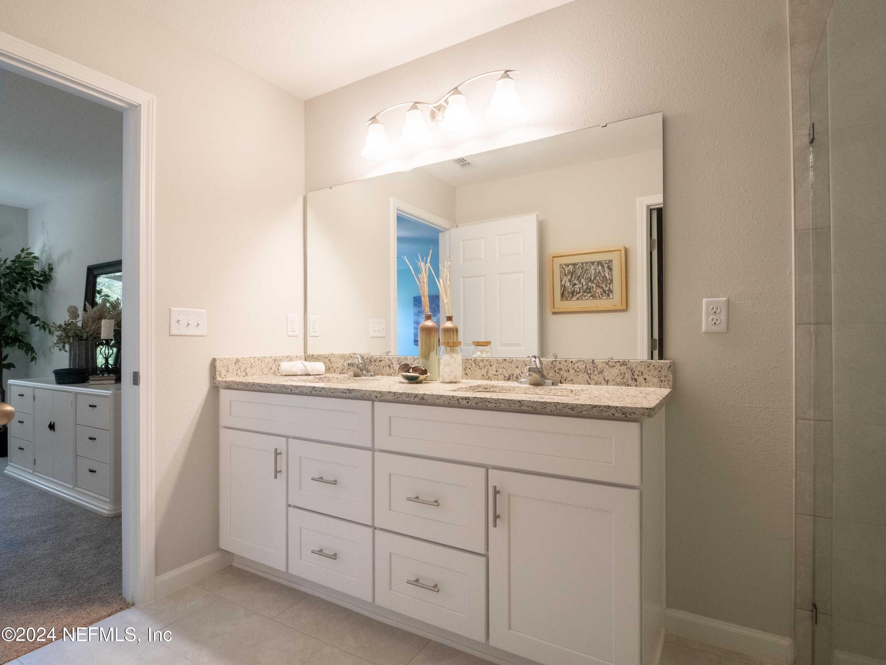 4011 Spring Glen Road Jacksonville, FL 32207 - Photo 29 of 38 a bathroom with a granite countertop sink and a mirror