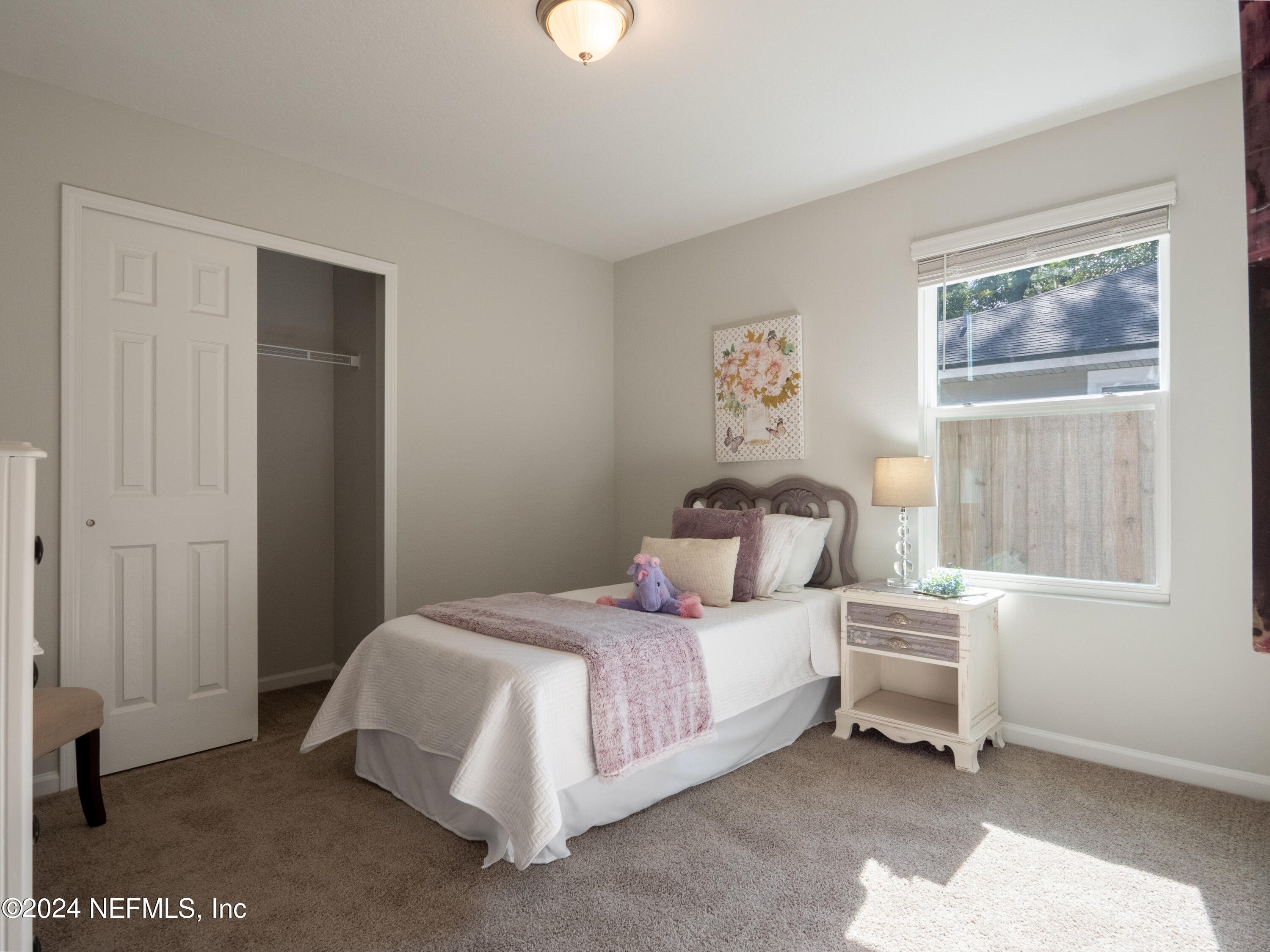 4011 Spring Glen Road Jacksonville, FL 32207 - Photo 31 of 38 a bedroom with a bed and a window