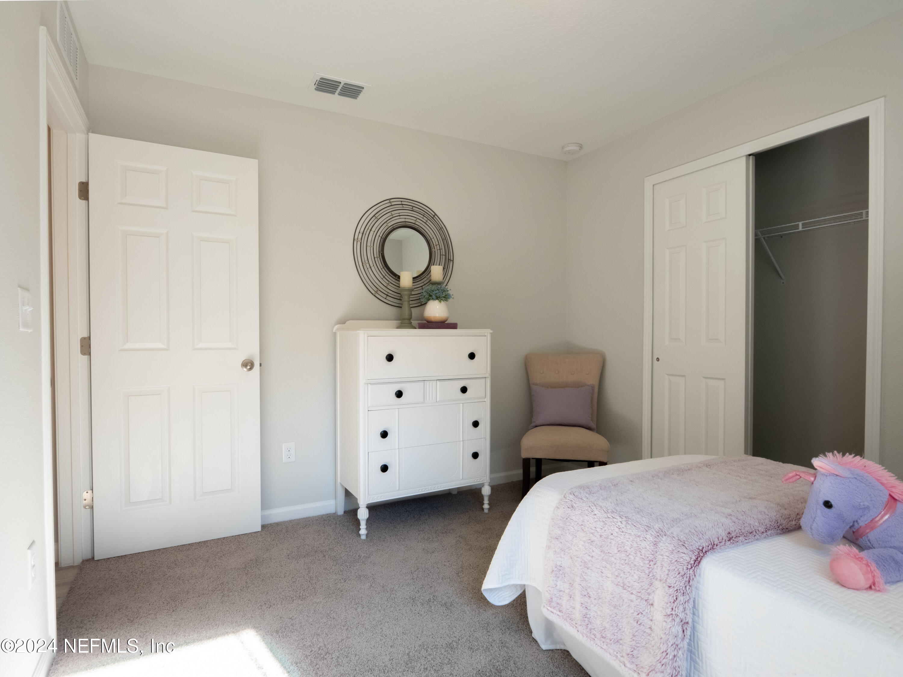 4011 Spring Glen Road Jacksonville, FL 32207 - Photo 32 of 38 a bedroom with a bed and a closet